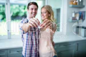 Cute couple showing their new home keys