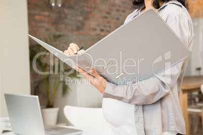Pregnant woman holding folder