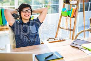 Smiling asian businessman listening to music