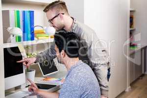 Serious gay couple using laptop