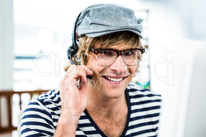 Smiling hipster businessman using headset