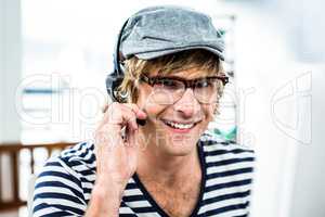 Smiling hipster businessman using headset