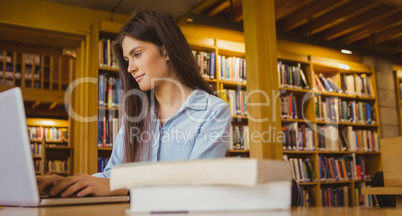 Smiling student working on laptop