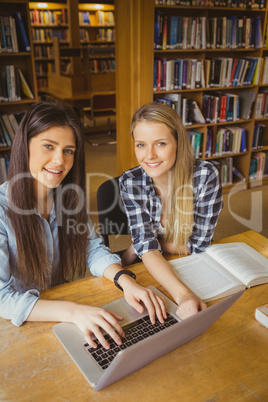 Smiling student working at library