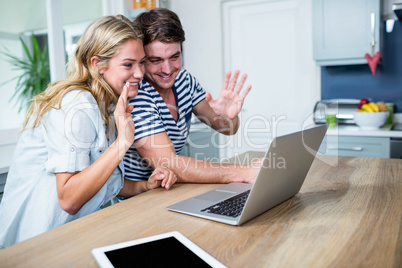 Happy couple using laptop