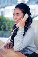 Smiling Asian woman on phone call