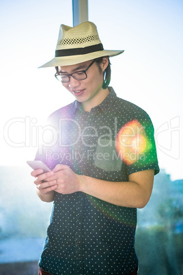 Smiling businessman texting