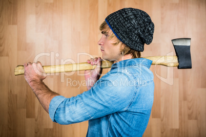 Side view of hipster standing with axe
