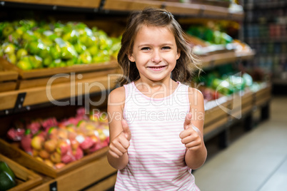 Portrait of little girl with thumps up