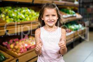 Portrait of little girl with thumps up