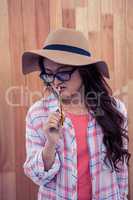Asian woman with hat holding pencil