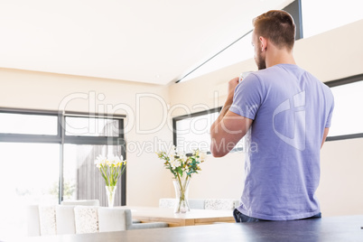 Rear view of handsome man drinking coffee