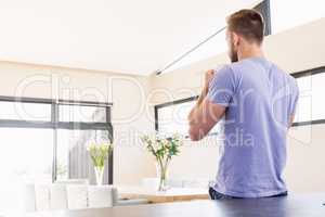 Rear view of handsome man drinking coffee