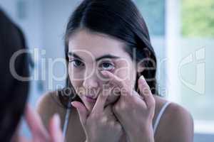 Brunette putting her contact lens