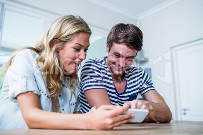 Focused couple using smartphone