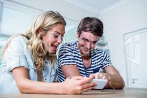 Focused couple using smartphone