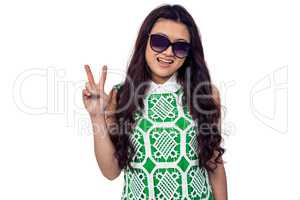 Asian woman with sunglasses making peace sign