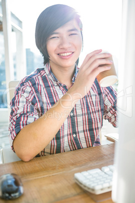 Smiling hipster businessman with take-away coffee