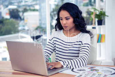 Creative businesswoman using laptop