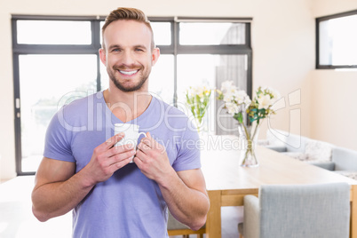 Smiling handsome man with mug