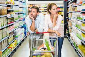 Thoughtful young couple doing shopping