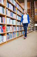 Female student walking in the library