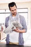 Handsome man reading newspaper