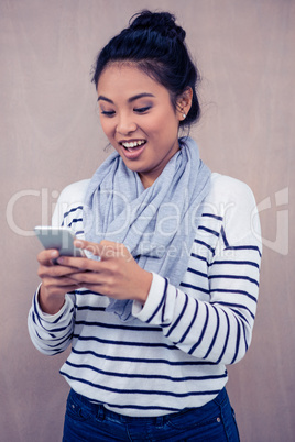 Surprised Asian woman using smartphone