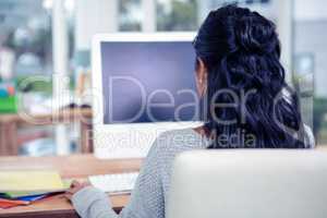 Rear view of woman using computer