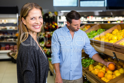 Happy couple doing grocery shopping