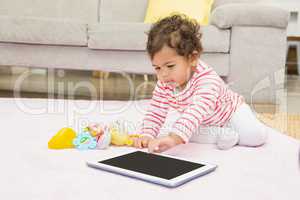 Cute baby on the carpet with tablet