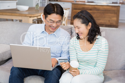 Happy couple shopping online