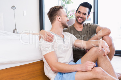 Happy gay couple looking at each other
