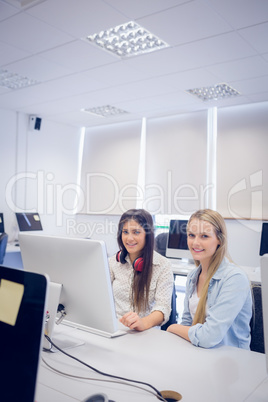 Smiling students using computer