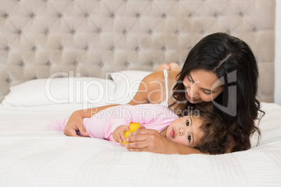 Brunette playing with her baby and a duck