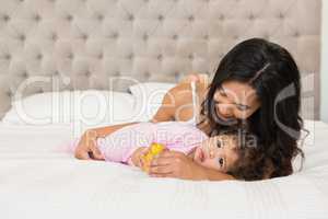 Brunette playing with her baby and a duck