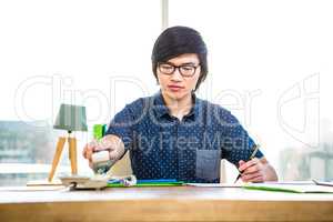 Smiling hipster businessman writing