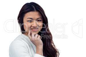 Smiling Asian woman with hand on chin looking at the camera