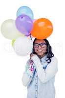 Asian woman holding colorful balloons