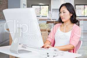 Serious pregnant woman using computer