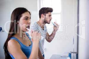 Young couple brushing teeth