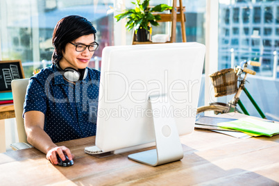 Smiling asian businessman using computer