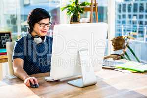 Smiling asian businessman using computer