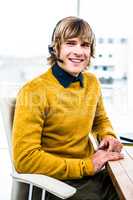 Smiling hipster businessman using headset