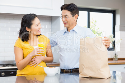 Happy expectant couple in the kitchen