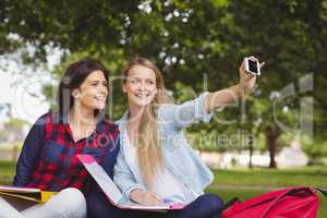 Smiling students taking a selfie outdoor