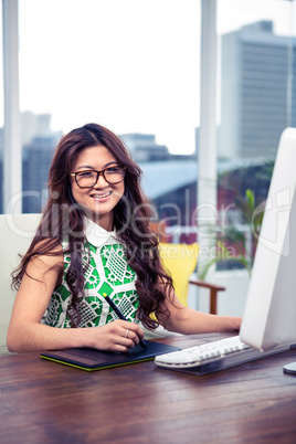 Smiling creative businesswoman using digital board