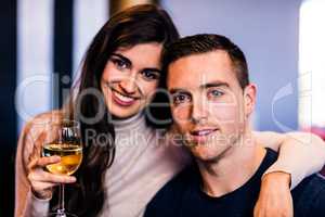 Portrait of couple holding glass of white wine