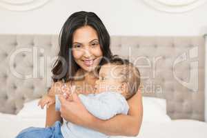 Happy brunette holding her baby