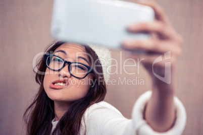 Asian woman making faces and taking selfie